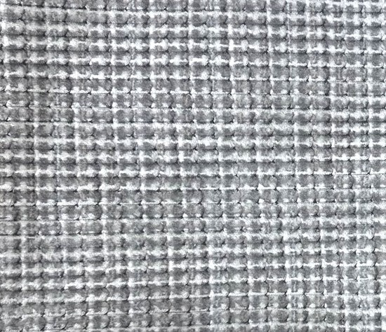 Close-up of a textured gray fabric with a subtle pattern