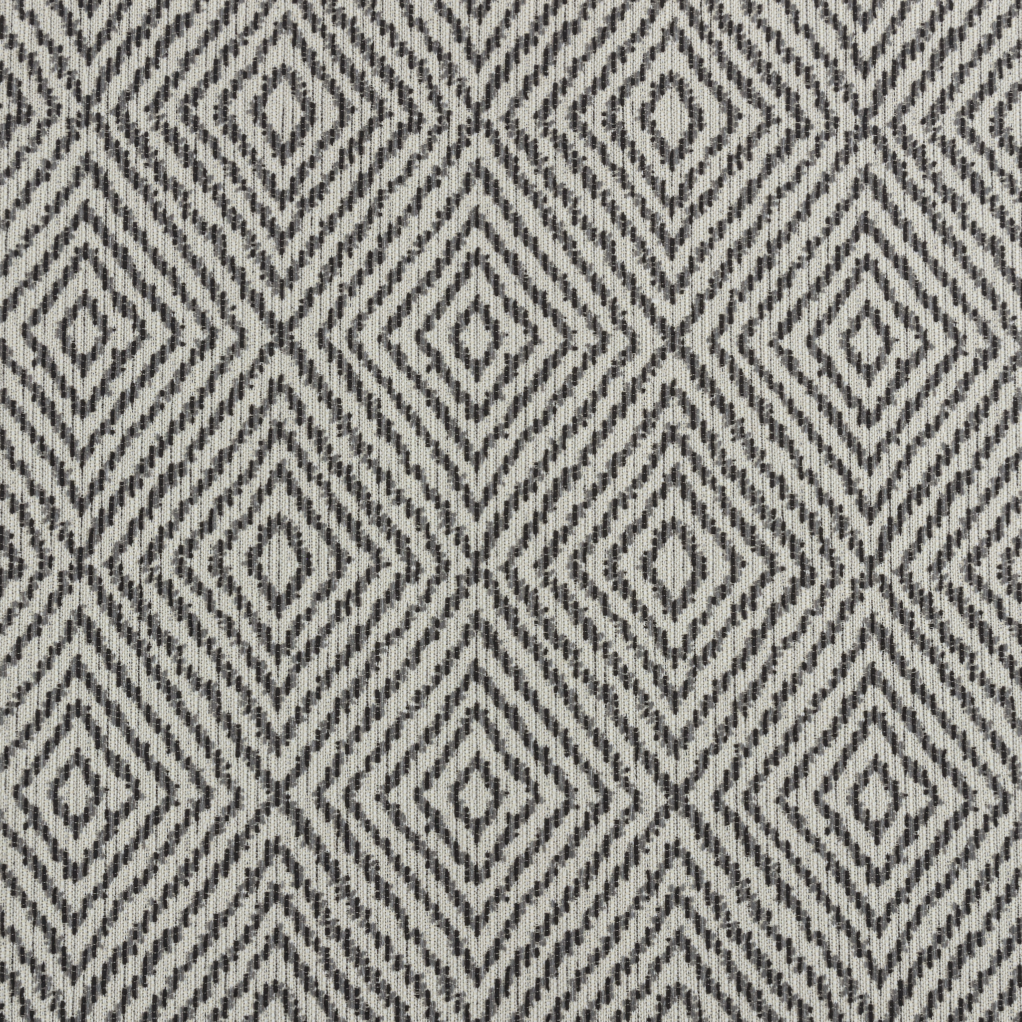 Patterned fabric with geometric diamond design in black and white.