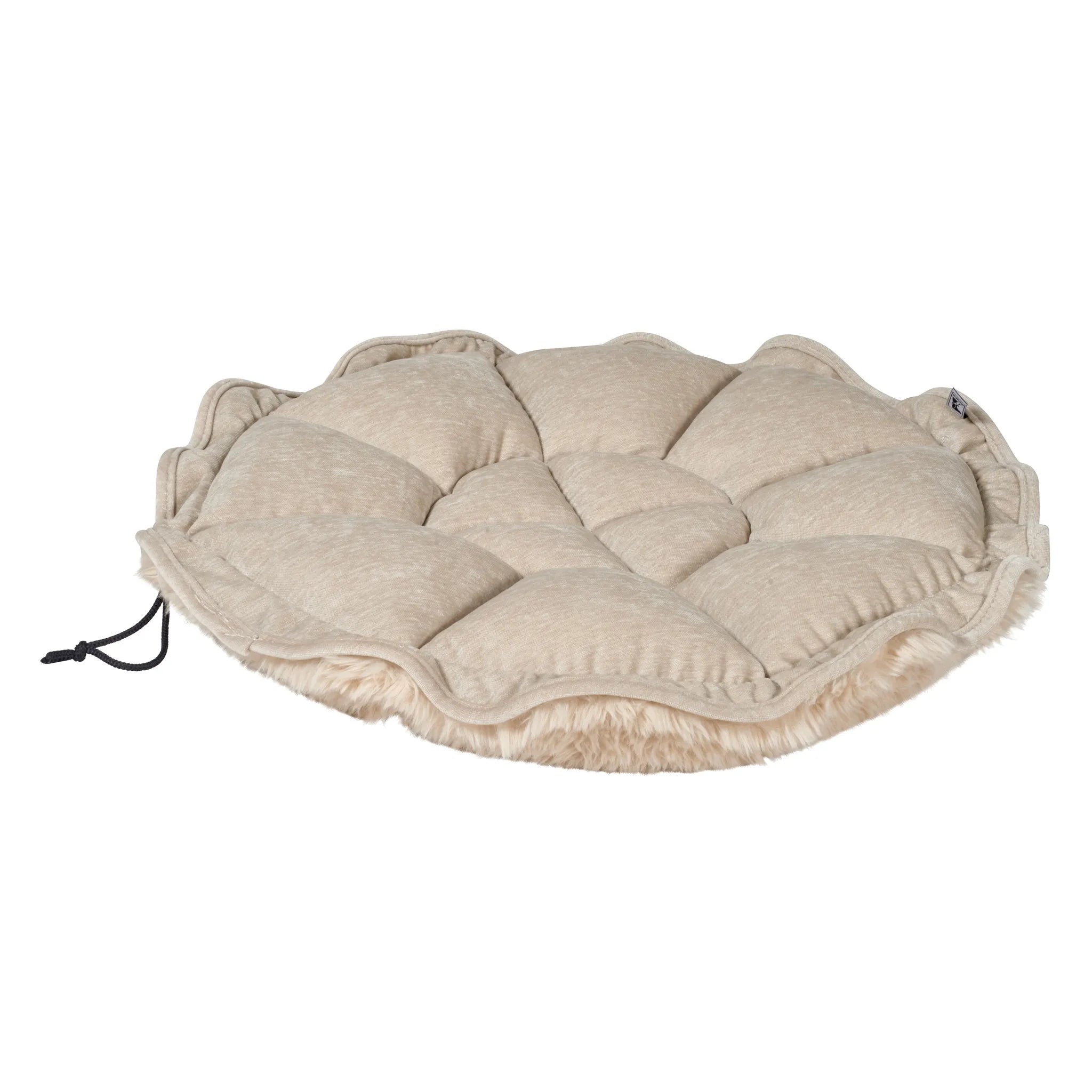 Round beige cushion with textured surface on a white background