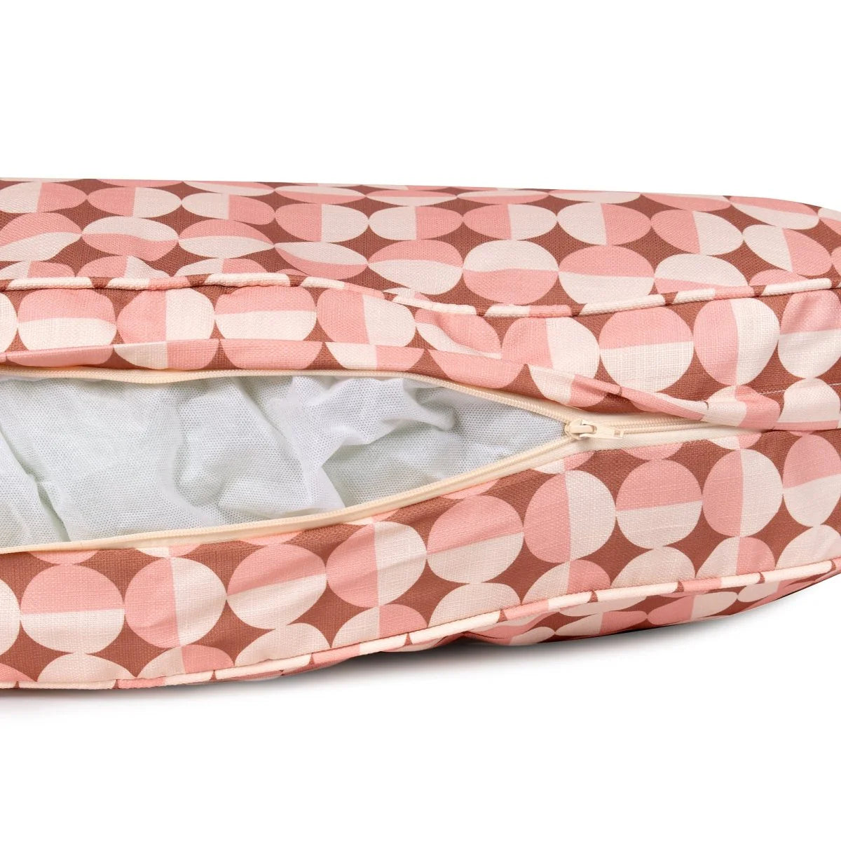 Pink and white patterned dog bed with a zipper on a white background