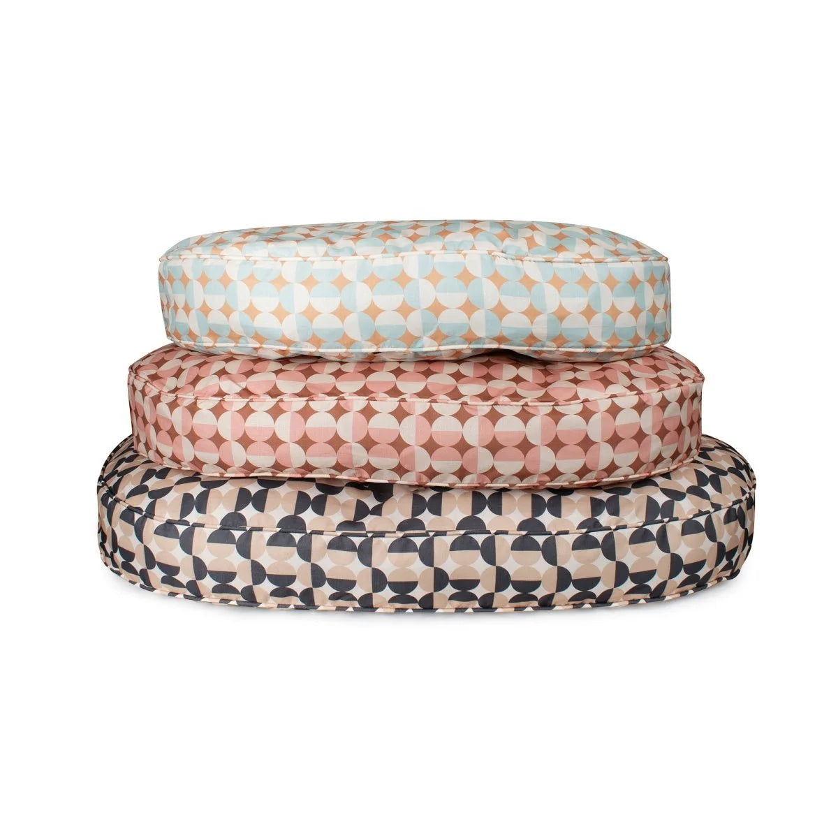 Three patterned cushions stacked on a white background