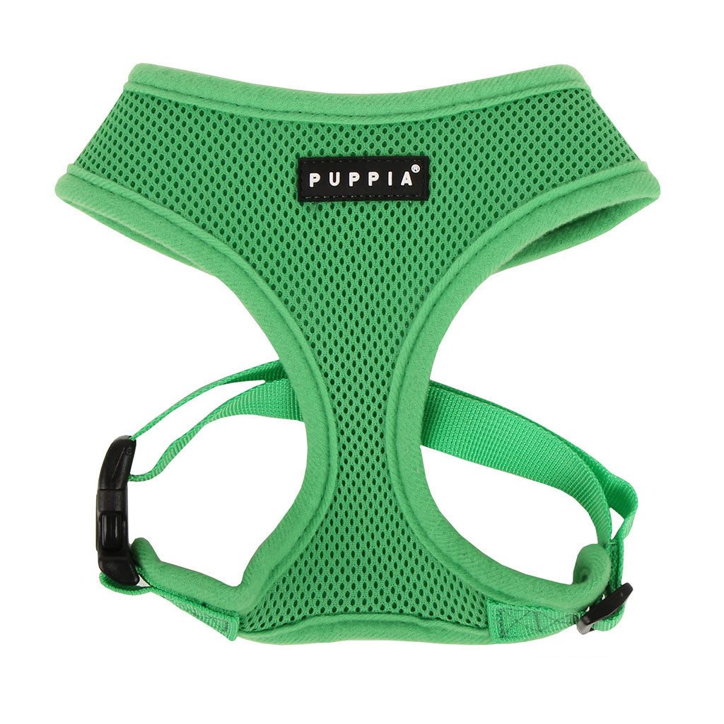 Green dog harness with Puppia label on a white background