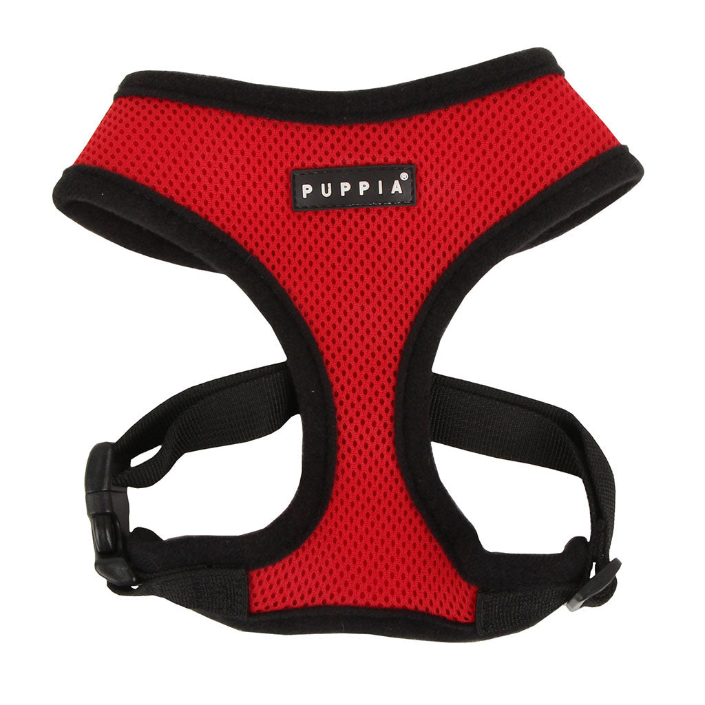 Red dog harness with black straps on a white background, featuring the Puppia brand.