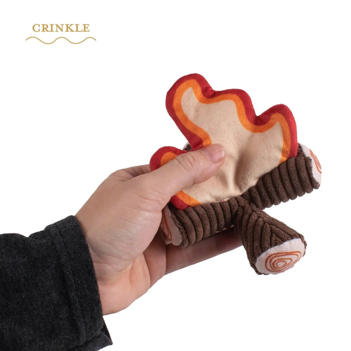 Hand holding a crinkle toy shaped like a leaf with 'Crinkle' branding.