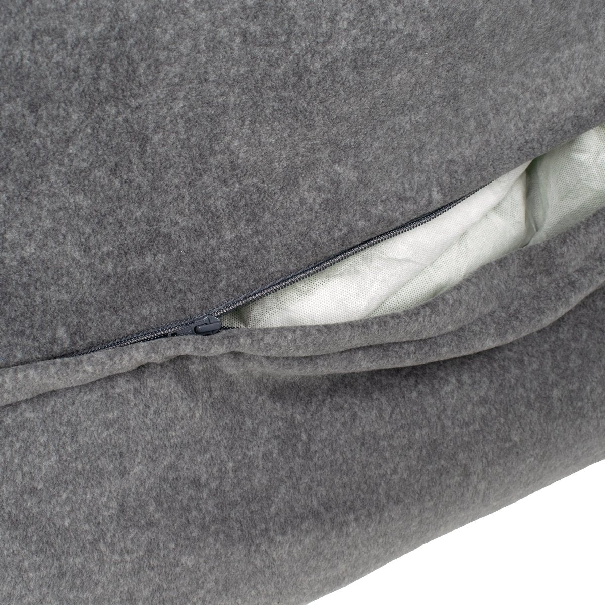 Gray cushion with a zipper showing white padding inside on a white background